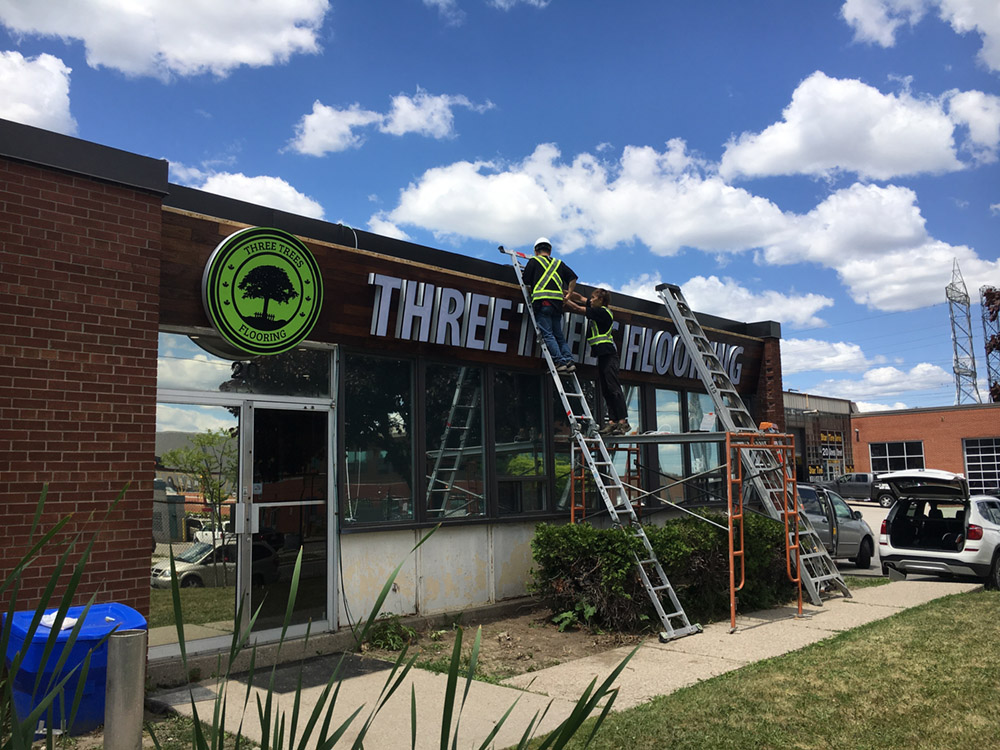 SignVillage fabrication team working on signage